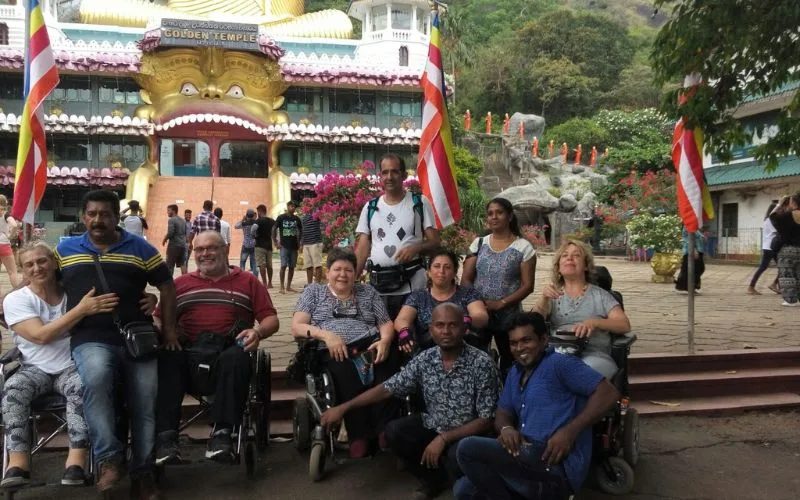 Travellers using wheelchairs on an accessible Sri Lanka tour at the Golden Temple of Dambulla